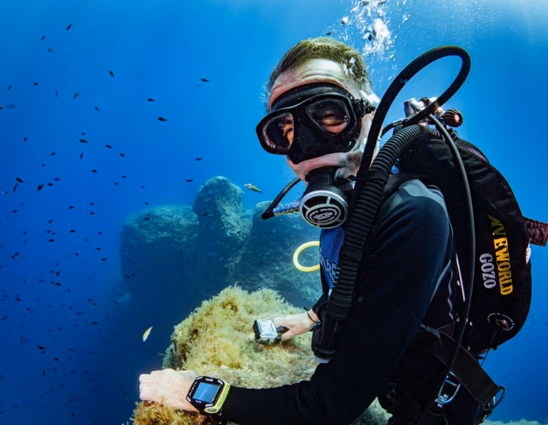A scuba diver diving in Middle Finger in Gozo with Blue Hole Diving Gozo. SSI Advanced Adventurer course - advanced diving course.
