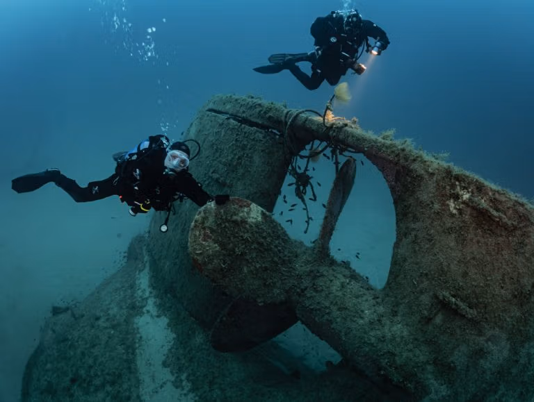 Divers diving on the MV Xlendi wreck in Gozo. Blue Hole Diving Gozo.