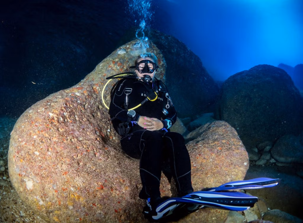 rock sitting diving in Cathedral Cave in Gozo with Blue Hole Diving Gozo Ltd.