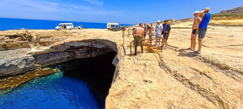 Divers preparing to enter the water at the Cathedral Cave (Blue Dome) in Gozo. Blue Hole Diving Gozo.