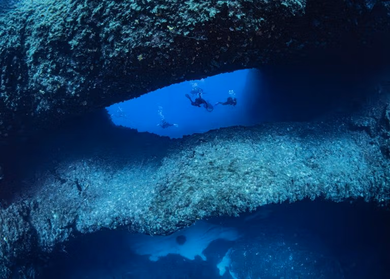 Scuba divers diving at Double Arch, Gozo with Blue Hole Diving Gozo. Deep Diving Course.