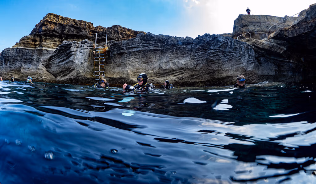 The route to the Cathedral Cave leads over rocks and down a ladder to the water
